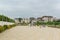 Vacationers on the picturesque blooming promenade of Adler on a cloudy summer day