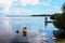 Vacationing - boys fishing on a dock and people snorkeling near the mangroves in  beautiful blue water under a perfect sky