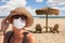 Vacationing Woman Wearing Face Mask on Sandy Beach