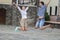 Vacations Travel Ideas. Happy Caucasian Couple Having Fun and Jumping Together During City Traveling