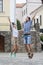 Vacations Travel Ideas. Happy Caucasian Couple Having Fun and Jumping Together With Outstretched Hands During Traveling in The