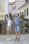 Vacations Travel Ideas. Happy Caucasian Couple Having Fun and Jumping Together With Outstretched Hands During Traveling in The