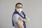 Vaccinated asian man in face mask showing medical plaster on arm studio shot