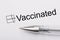 Vaccinated - checkbox with a cross on white paper with pen. Checklist concept