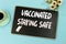 Vaccinated staying safe message on chalkboard, desktop : coffee and flowers pot