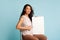 Vaccinated Woman Holding Empty Paper Board Sitting Over Blue Background