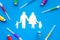 Vaccination as way to save healthy family. Syringe with colored vaccine near silhouette of family on blue background top