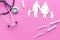 Vaccination as way to save healthy family. Syringe with colored vaccine near silhouette of family on pink background top