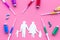 Vaccination as way to save healthy family. Syringe with colored vaccine near silhouette of family on pink background top