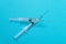 Vaccination or Revaccination Concept - Two Medical Syringe on Blue Table