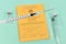 Vaccine concept with close up of  syringe in front of blurry yellow international certificate of vaccination