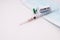 Vaccine for covid-19, syringe and disposable medical mask on white background