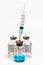 Vaccine in vial with syringe on a white background.