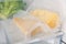 Vacuum bags with cheese pieces in fridge, closeup. Food storage