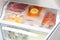 Vacuum bags with different products in fridge. Food storage