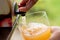 Vacuum boxed apple juice being poured into a glass