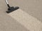 Vacuum cleaner hoover on dirty carpet. House cleaning concept