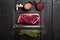 Vacuum packed beef, on black wooden table background, top view flat lay, with copy space for text