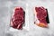 Vacuum packed beef, on gray stone table background, with copy space for text