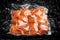 Vacuum-packed meat, on dark ice background, chicken fillet. Semifinished