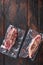 Vacuum packed meat , top blade beef steak on dark old wooden table, top view with space for text