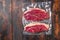 Vacuum packed picanha steak from organic  beef on dark old wooden table, top view space for text