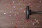 Vacuuming confetti from wooden floor. Space for text