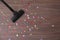 Vacuuming confetti from wooden floor, top view. Space for text