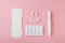 Vaginal suppositories, tablets, applicator and sanitary napkin on pink background