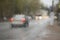 The vague image of the car through the glass which is filled in with a rain