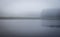 Vague misty and mysterious landscape with channel and grass river bank