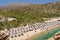 VAI, CRETE - 15 JULY 2021: Crowds of tourists on the picturesque palm fringed beach of Vai on the eastern coast of Crete Greece