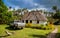 Vailala, Wallis and Futuna. A typical rural cottage in Wallis resembles traditional thatched roof Polynesian fale. Pickup car.