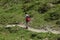 Val d`Aosta, Italy, July 5 2018: male teenager walking alone on a mountain trial