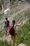 Val d`Aosta, Italy, July 5 2018 two hikers walking on a mountain trial on Italian Alps