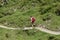 Val d`Aosta, Italy, July 5 2018: woman walking alone on a mountain trial