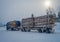 Valdres, Norway - March 26, 2018: Outdoor view of huge truck transport trunks or lumber in a road covered with snow