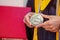 Valedictorian Shows off Medal with Graduation Gown