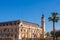 Valencia Port building with tower and palm tree