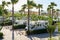 Valencia, Spain, April 06, 2023: A group of of caravans and camper vans parked between palm trees, in the Vera campsite