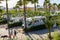 Valencia, Spain, April 06, 2023: A group of of caravans and camper vans parked between palm trees, in the Vera campsite. And two
