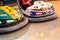 Valencia, Spain - December 14, 2018: Two children`s bumper cars competing among them at an amusement park