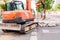 Valencia, Spain - July 2, 2019: Operator drives a pneumatic hammer to break the pavement of a street to repair it