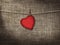 Valentine card heart shaped from old red paperr hanging on a clo