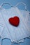 Valentine composition of red heart on face masks isolated on blue background