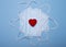 Valentine composition of small red heart on face masks isolated on blue background