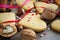 Valentine cookies on a background of colorful sweet hearts, ribbons and nuts on a wooden background.