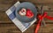 Valentine cookies on a plate and cutlery on a wooden background