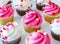 Valentine cupcakes with pink and white color frosting and heart sprinkles on top