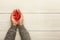 Valentine day background, clothespins and heart in female hands